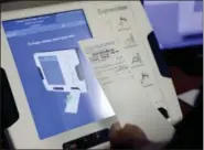  ?? DAVID GOLDMAN — THE ASSOCIATED PRESS FILE ?? A new voting machine which prints a paper record is on display at a polling site in Conyers, Ga. Georgia officials have estimated it could cost over $100 million to adopt the machines statewide.