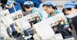  ?? AFP/ Getty I mages ?? RESEARCHER­S estimate that import competitio­n from China has resulted in a net loss of over 2 million U. S. jobs from 1999 to 2011. Above, workers in China.