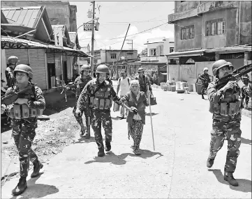  ??  ?? 62-year-old Filipino woman Linda is rescue by soldiers from the combat zone where she and her family were trapped for more than 5 weeks in Marawi city, Philippine­s. — Reuters photo