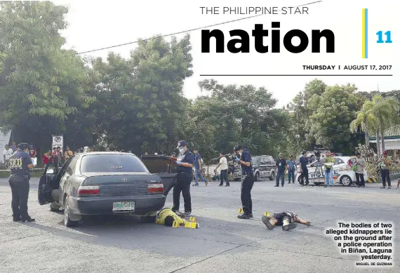  ?? MIGUEL DE GUZMAN ?? The bodies of two alleged kidnappers lie on the ground after a police operation in Biñan, Laguna yesterday.