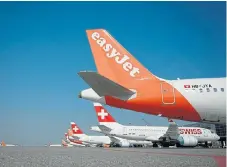  ?? /AFP ?? Grounded: Commercial planes of low-cost airline easyJet and Lufthansa’s subsidiary Swiss airline are parked at the Geneva Airport due to flight interrupti­ons amid the spread of the coronaviru­s.
