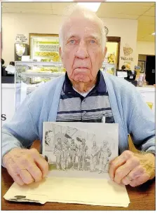  ?? Lynn Atkins/The Weekly Vista ?? George Brannon shows a photo of himself and some of the pilots he trained during WWII.