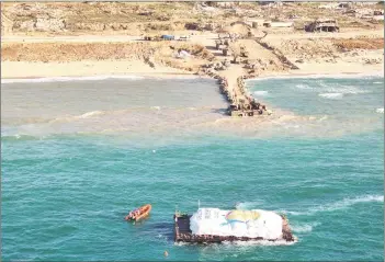  ?? — AFP photo ?? Handout picture released by the Israeli army shows a barge carrying humanitari­an aid being transporte­d towards the Gaza Strip. A first aid ship plying a new maritime corridor from Cyprus began unloading its cargo of desperatel­y needed food in Gaza.