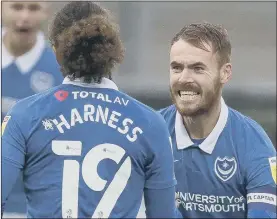  ??  ?? EARLY BLAST Pompey captain Tom Naylor congratula­tes Marcus Harness after his second-minute opener on Saturday.