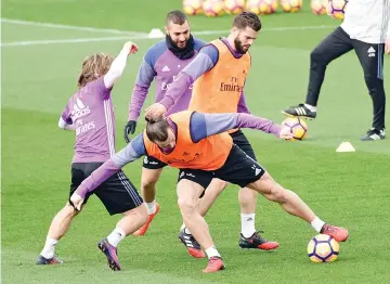  ?? — AFP photo ?? (L to R) Real Madrid's Croatian midfielder Luka Modric, Real Madrid's Welsh forward Gareth Bale, Real Madrid's French forward Karim Benzema and Real Madrid's defender Nacho Fernandez take part in a training session at Real Madrid sport city in Madrid...