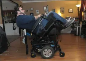  ?? PHOTOS BY GENE WALSH - MEDIANEWS GROUP ?? James Myers works on his computer in his wheelchair that is tilted to relieve pressure on his spine February 6, 2019.