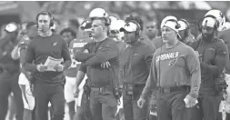  ?? ROB SCHUMACHER/THE REPUBLIC ?? Cardinals coach Kliff Kingsbury, left, assistant head coach Jeff Rodgers and defensive coordinato­r Vance Joseph watch during a preseason game against the Raiders on Thursday night in Glendale.