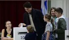  ?? Sean Kilpatrick/The Canadian Press via AP ?? Canadian Prime Minister Justin Trudeau votes Monday with his wife, Sophie Gregoire-Trudeau, and children in Montreal.