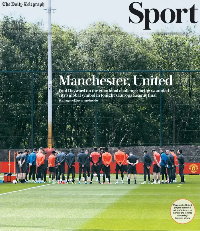  ??  ?? Manchester United players observe a minute’s silence to honour the victims of Monday’s terrorist attack