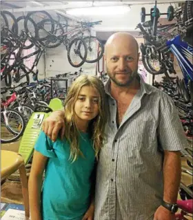  ?? PROVIDED ?? Lance Margolis at his far-out Israeli bike shop with customer, Stan’s grandson, Ariel, with him.