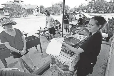  ?? ERIC GAY/AP ?? El Pavo Real restaurant owner Lindsey Mclellan serves up a free steak taco meal in Hurricane Ida’s wake Wednesday in New Orleans.