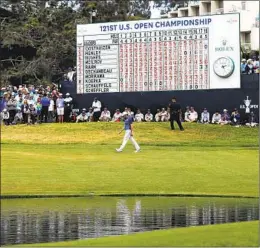  ?? K.C. ALFRED U-T ?? Fans crowd the 18th hole as Louis Oosthuizen, who came in second, walks down the fairway. The excitement at the hole already had happened for Jon Rahm.