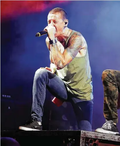  ??  ?? Chester Bennington, left, committed suicide last year, leaving Linkin Park bandmates shocked and mourn Traumatic,” to process his grief.