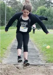  ??  ?? Cailtyn Beale leaps into the long jump pit.