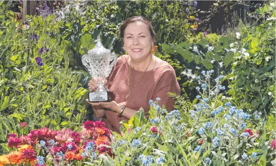  ?? Picture: Nev Madsen ?? SURPRISE WIN: Leisa Rossignol in her Chronicle Garden Competitio­n Grand Champion winning garden, designed and made with her husband Serge. You can find their beautiful garden at 112 Neil St.