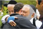  ?? K.C. ALFRED U-T FILE ?? Rabbi Yisroel Goldstein hugs a member of Chabad of Poway the day after the April 27, 2019, shooting.