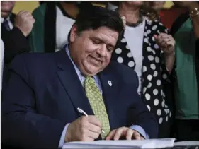  ?? AP PHOTO/AMR ALFIKY FILE ?? In this June 25 file photo, Gov. J. B. Pritzker signs a bill in Chicago.