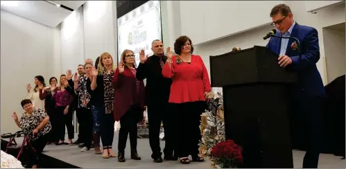  ?? LOANED PHOTOS ?? OFFICERS AND DIRECTORS of the Yuma Associatio­n of Realtors take the oath of office as Wayne Eide conducts the installati­on ceremony in December.