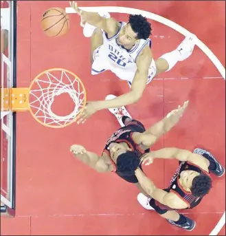  ??  ?? Duke center Marques Bolden (20) shoots next to Louisville center Steven Enoch (center), and forward DwayneSutt­on during the first half of an NCAA college basketball game in Louisville, Kentucky on Feb 12. (AP)