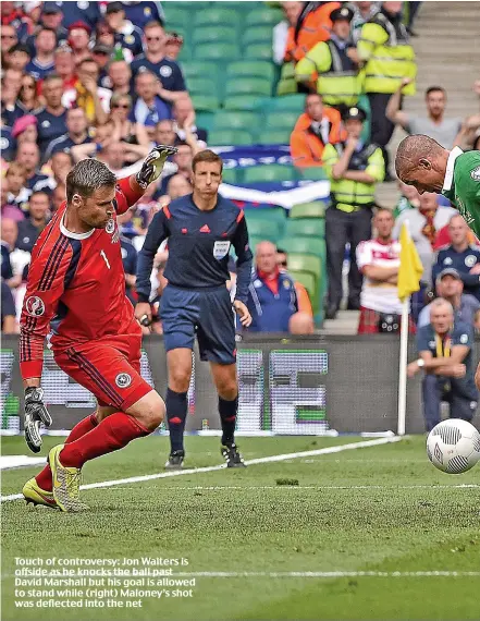  ??  ?? Touch of controvers­y: Jon Walters is offside as he knocks the ball past David Marshall but his goal is allowed to stand while (right) Maloney’s shot was deflected into the net