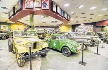  ?? RICARDO RAMIREZ BUXEDA/ORLANDO SENTINEL PHOTOS ?? Vehicles stand in the Military Pavilion at the Orlando Auto Museum at Dezerland Park on March 15. Dezerland is a combinatio­n auto museum and fun center in the old Artegon mall. It has been in soft opening since December. The property is owned by real estate mogul and Donald Trump associate Michael Dezer.