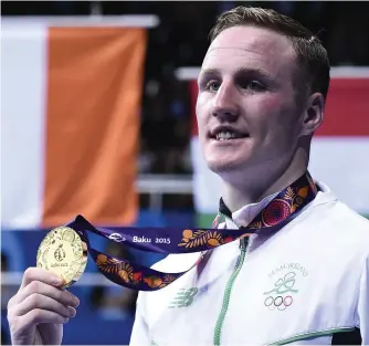  ??  ?? Ireland’s Michael O’Reilly poses with his gold medal after winning the men’s middleweig­ht event at the European Games in Baku in June 2015