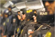  ?? Anupam Nath / Associated Press ?? Members of the Rapid Action Battalion police unit guard a street in Dhaka before Sunday’s elections.