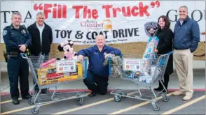  ?? WILLIAM HARVEY/THREE RIVERS EDITION ?? From left, Brian Duke; Tim Hammack; Rick Jackson; Kristen Boswell, executive director of the Beebe Chamber of Commerce; and Butch Rice, president and CEO of Stallion Transporta­tion, participat­e in the Fill the Truck Toy and Coat Drive at the Walmart...