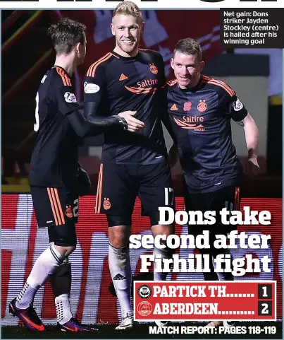  ??  ?? Net gain: Dons striker Jayden Stockley (centre) is hailed after his winning goal