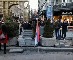  ?? (Reuters) ?? A MAN holds a Serbian flag on a street corner in Belgrade.