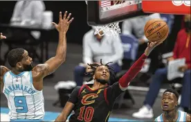  ?? NELL REDMOND/ASSOCIATED PRESS ?? Cleveland Cavaliers guard Darius Garland (10) drives to the basket past Charlotte Hornets guard Brad Wanamaker (9) during the second quarter of an NBA basketball game in Charlotte, N.C., Wednesday.