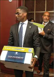  ?? CLEVELAND.COM ?? Cleveland Mayor Justin Bibb (left) and City Council President Blaine Griffin hand deliver court motions on April 6 that seek to wipe clean low-level marijuana conviction­s and charges.