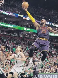  ?? AP PHOTO ?? Cleveland Cavaliers forward LeBron James, right, soars to the basket over Boston Celtics forward Jae Crowder, left, and centre Kelly Olynyk during Game 5 of the NBA semifinals.