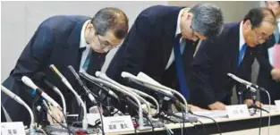  ??  ?? Takada (left) bows with other executives at the end of a press conference in Tokyo on Monday.