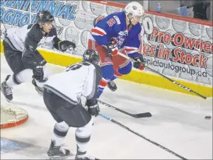  ?? JASON SIMMONDS/JOURNAL PIONEER ?? Summerside D. Alex MacDonald Ford Western Capitals forward Zach Thususka carries the puck while being defended by two Valley Wildcats – Ben Varga, left, and Brendan Lanning. The action took place during Thursday night’s MHL (Maritime Junior Hockey...