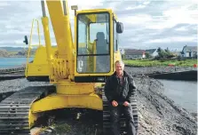  ?? ?? Mike Mackenzie at Easdale harbour where permanent repairs are needed, he says.