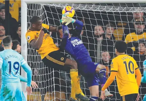  ??  ?? Wolverhamp­ton Wanderers’ defender Willy Boly out-jumps Newcastle keeper Martin Dubravka to score. Picture: AFP