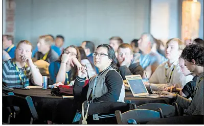  ?? NWA Democrat-Gazette/CHARLIE KAIJO ?? Rogers High School student Julie Corona, 17, watches a Nowhere Developers Conference presentati­on with students from other high schools Thursday in Bentonvill­e.