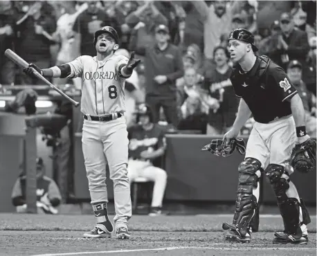  ?? Andy Cross, The Denver Post ?? Rockies left fielder Gerardo Parra reacts to being called out on strikes in the sixth inning at Miller Park during Game 2 of the NLDS on Friday. Parra had two of the Rockies six hits in the game.