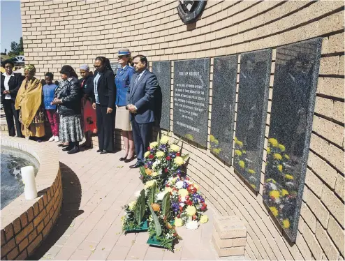  ?? Picture: Jacques Nelles ?? Alderman Derrick Kissoondut­h, member of the mayoral committee for community safety, right, stands by the wall of rememberan­ce with families of the fallen and police officials at the ceremony in Pretoria yesterday.