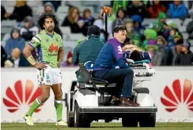  ?? PHOTO: MARK NOLAN/GETTY IMAGES. ?? Canberra backrower Iosia Soliola looks on as Melbourne’s Billy Slater is driven off GIO Stadium.