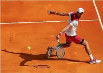  ?? GETTY IMAGES ?? Novak Djokovic plays a backhand while on the move in the first round of the Monte Carlo Masters.