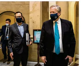  ??  ?? White House chief of staff Mark Meadows (right) and Treasury Secretary Steven Mnuchin arrive at the office of House Speaker Nancy Pelosi at the Capitol to resume talks on a COVID-19 relief bill Saturday in Washington.