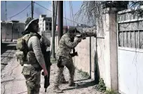  ?? Aris Messinis / AFP ?? Iraqi soldiers patrol an area of west Mosul retaken from ISIL fighters as they advance in the battle to seize the city.