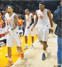  ?? THE ASSOCIATED PRESS ?? Tennessee guard Lamonte Turner (1), forward Admiral Schofield (5) and teammates leave the court after being defeated, 94-84, by Auburn on Tuesday.