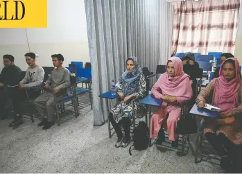  ?? AAMIR QURESHI / AFP VIA GETTY IMAGES ?? Students attend a class partitione­d by a curtain at a private university in Kabul on Tuesday.