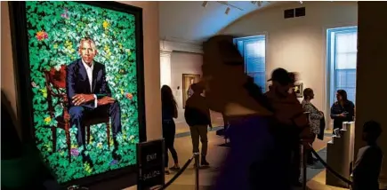  ?? GETTY ?? Visitors view the recently unveiled portrait of former President Barack Obama by Kehinde Wiley at the National Portrait Gallery in Washington, D.C., in 2018.