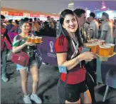  ?? AP ?? Fans carry their beer at a fan zone ahead of the FIFA World Cup in Doha, Qatar on Saturday.