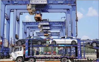  ?? TANG KE / FOR CHINA DAILY ?? A batch of domestical­ly made cars is loaded at Yantai Port in Shandong province in August.