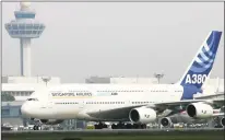  ?? Roslan Rahman / Getty Images file photo ?? The Airbus A380, the largest passenger jet, completes its first test flight outside Europe after landing at the Changi Internatio­nal Airport terminal in Singapore in November 2005.